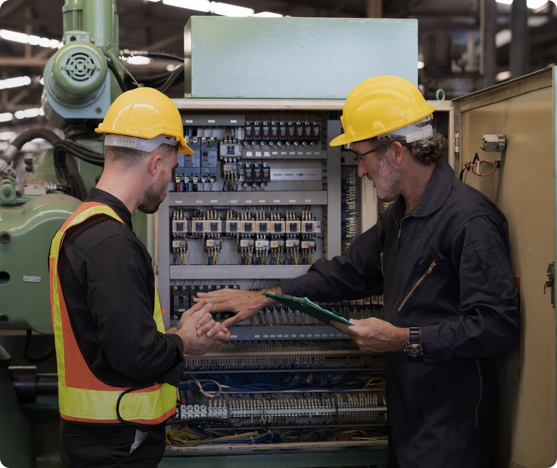 Workers examining electrical equipment